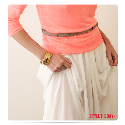 Belted coral sweater and floor length cream skirt